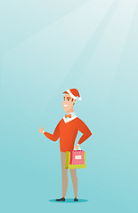 Image showing Man in santa hat shopping for christmas gifts.