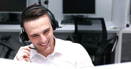 Image showing male call centre operator doing his job