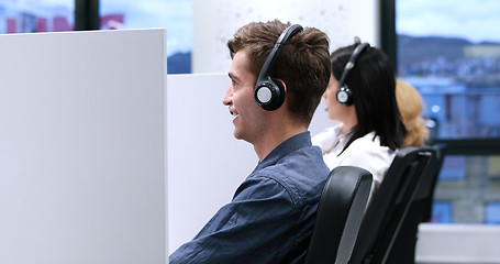 Image showing male call centre operator doing his job