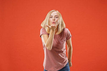 Image showing Portrait of attractive cute girl with kiss isolated over red background