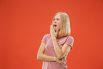 Image showing Beautiful bored woman bored isolated on red background