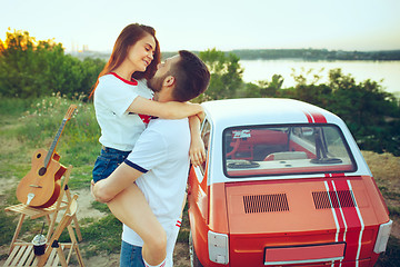 Image showing Couple sitting and resting on the beach on a summer day near river