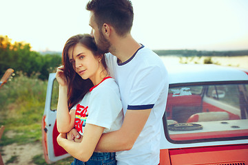 Image showing Couple resting on the beach on a summer day near river