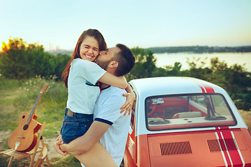 Image showing Couple sitting and resting on the beach on a summer day near river