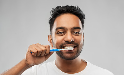 Image showing indian man with toothbrush cleaning teeth