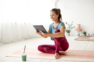 Image showing woman with tablet pc and drink at yoga studio