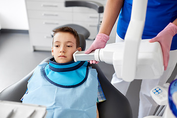 Image showing dentist making x-ray of kid teeth at dental clinic