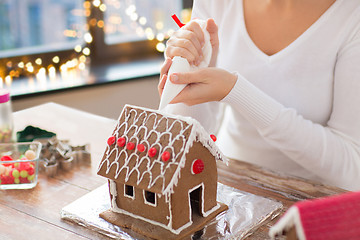 Image showing woman making gingerbread houses on christmas