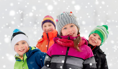 Image showing happy little kids in winter clothes outdoors