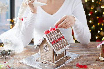 Image showing close up of woman making gingerbread house