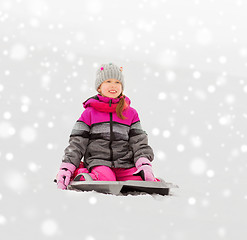 Image showing happy little girl on sled outdoors in winter