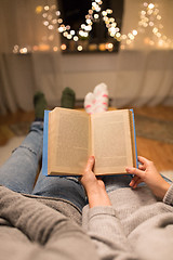 Image showing close up of couple reading book at home