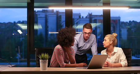 Image showing Multiethnic startup business team in night office