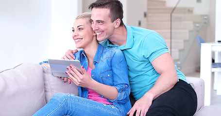 Image showing couple relaxing at  home with tablet computers