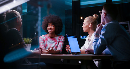 Image showing Multiethnic startup business team in night office