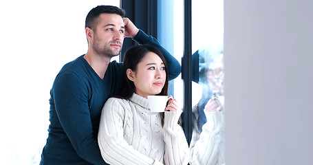 Image showing multiethnic couple relaxing at modern home indoors