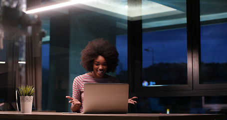 Image showing black businesswoman using a laptop in night startup office