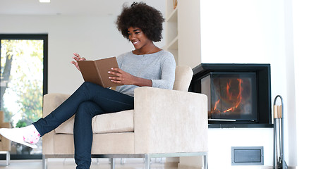Image showing black woman at home reading book