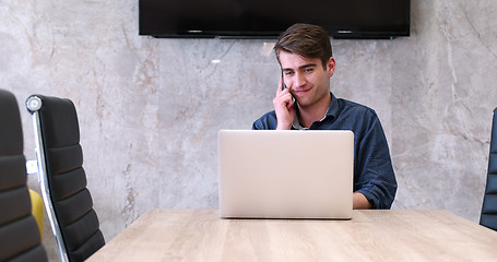 Image showing businessman working using a laptop in startup office