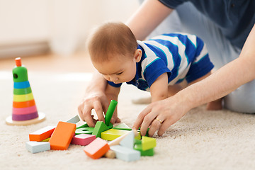 Image showing baby boy and father playing with toys at home