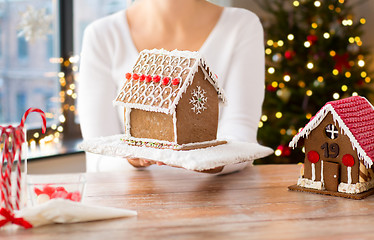 Image showing close up of woman with christmas gingerbread house