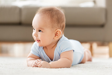 Image showing sweet little asian baby boy lying on floor at home