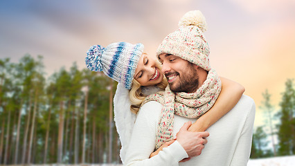 Image showing couple hugging over winter forest background