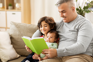 Image showing happy father with sons reading book at home