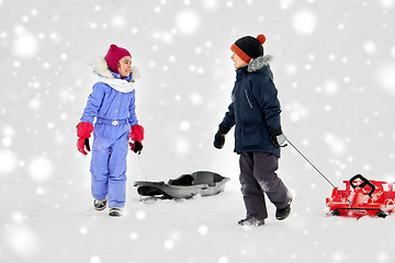 Image showing happy little kids with sleds in winter