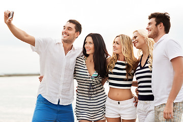 Image showing happy friends taking selfie on summer beach