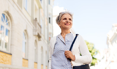 Image showing happy senior woman on city street in summer