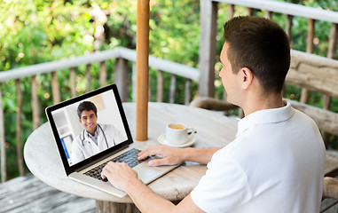 Image showing man having video chat with doctor on laptop