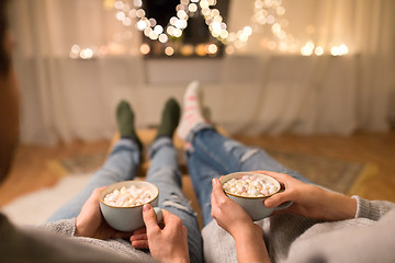 Image showing close up of couple drinking hot chocolate at home