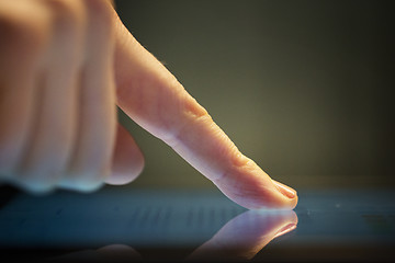 Image showing close up of hand using computer touch screen