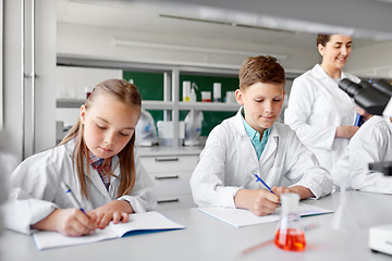 Image showing teacher and students studying chemistry at school