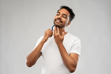 Image showing indian man shaving beard with razor blade