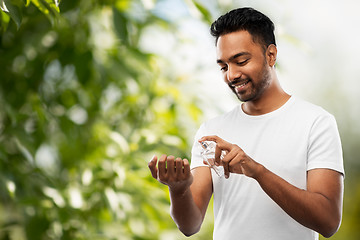 Image showing indian man with perfume over natural background