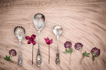 Image showing Dried purple flowers and vintage silver spoons