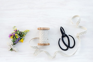 Image showing Bouquet of wildflowers with ribbon and scissors