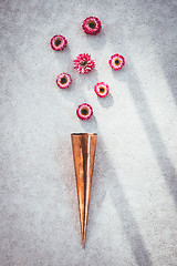 Image showing Copper cone and strawflowers on concrete background