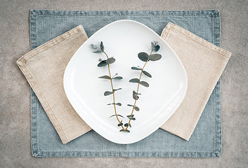 Image showing Eucalyptus on a white plate and linen napkins