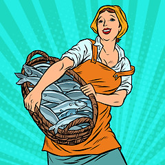 Image showing woman fisherman with a basket of fish. oceanic herring and cod