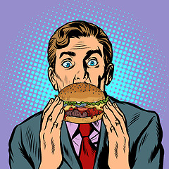 Image showing surprised man eating Burger