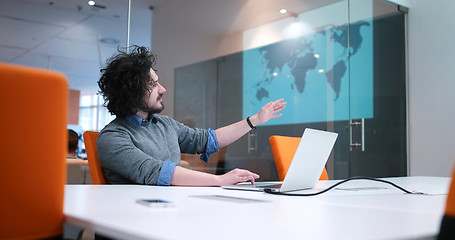 Image showing businessman working using a laptop in startup office