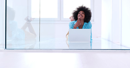 Image showing black women using laptop computer on the floor