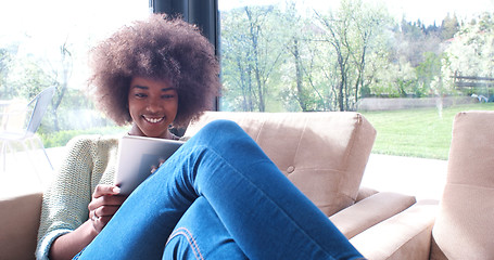 Image showing african american woman at home using digital tablet