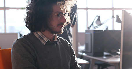 Image showing businessman working using a computer in startup office