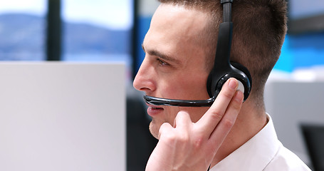 Image showing male call centre operator doing his job