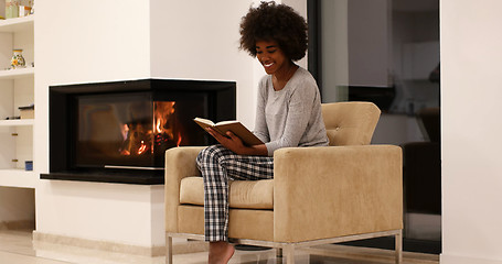 Image showing black woman at home reading book