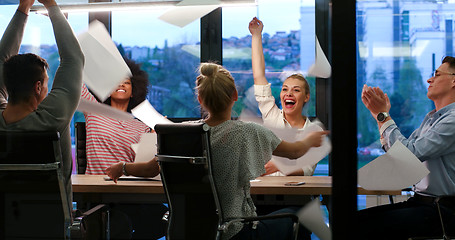 Image showing multiethnic Group of young business people throwing documents